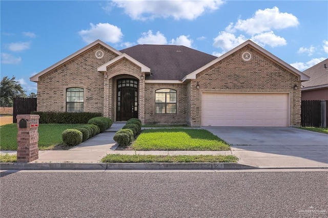 3517 N 43rd St, Mcallen, TX 78501 - view of front facade featuring brick siding, an attached garage, and concrete driveway