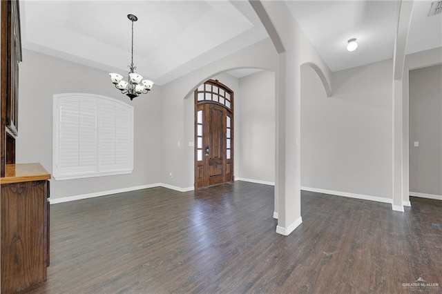 3517 N 43rd St, Mcallen, TX 78501 - entrance foyer with arched walkways, a chandelier, dark wood finished floors, and a tray ceiling