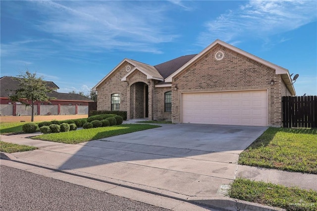 3517 N 43rd St, Mcallen, TX 78501 - view of front of home featuring brick siding, driveway, and a garage