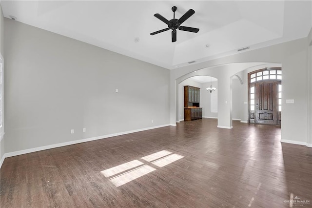 3517 N 43rd St, Mcallen, TX 78501 - unfurnished living room featuring arched walkways, a chandelier, wood finished floors, a tray ceiling, and a ceiling fan
