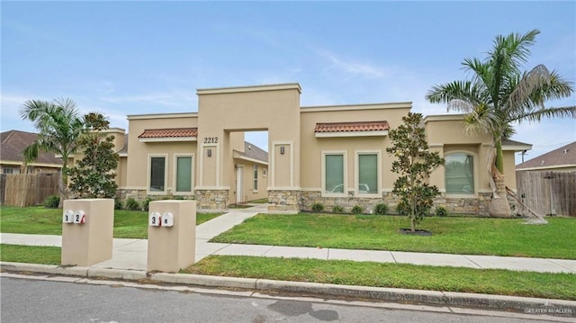 pueblo-style house with a front yard