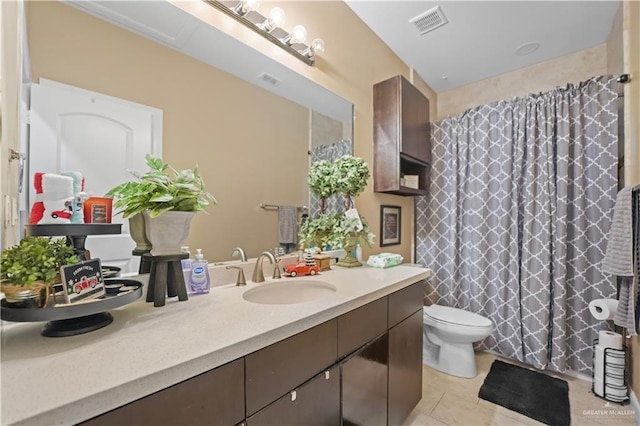 bathroom featuring toilet, vanity, tile patterned floors, and curtained shower