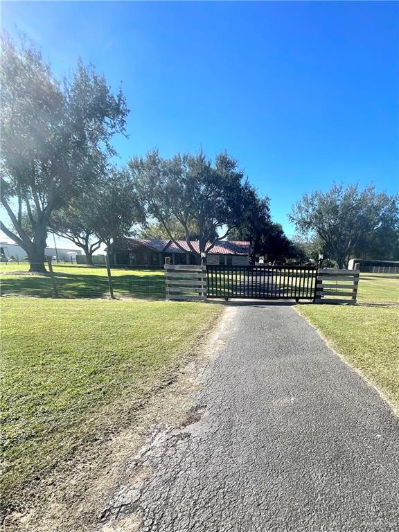 view of gate featuring a yard