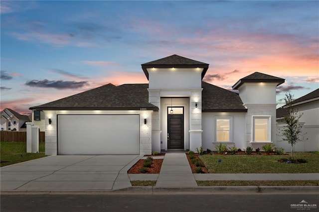 view of front of home with a garage and a yard