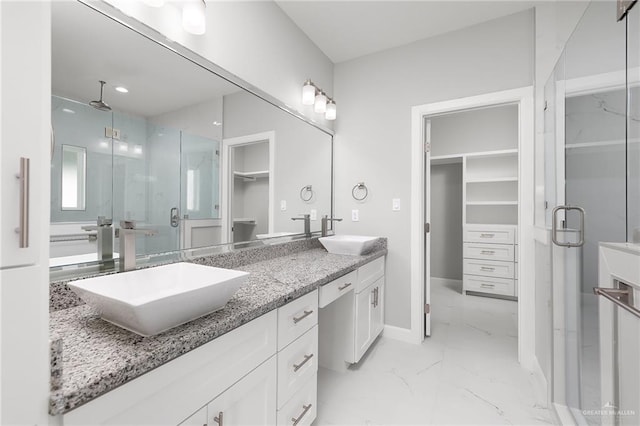 bathroom featuring vanity and a shower with shower door