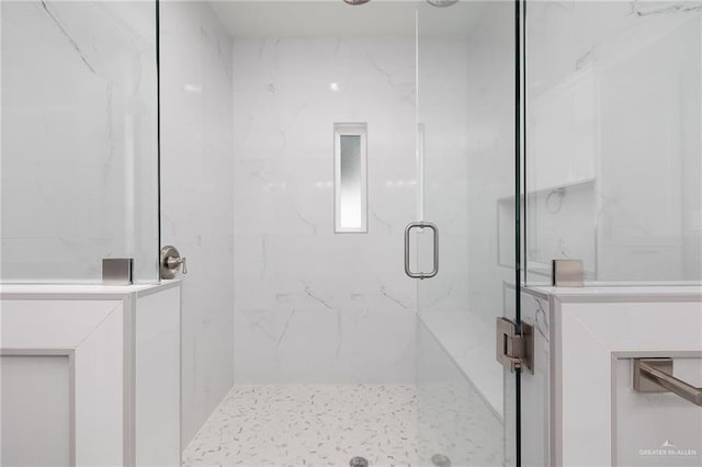 bathroom with a shower with door