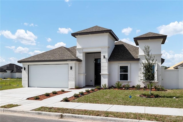 view of front of home with a front yard and a garage