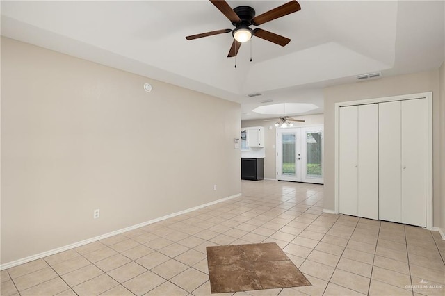 unfurnished living room featuring ceiling fan, light tile patterned flooring, and french doors