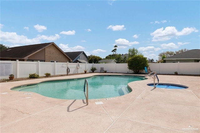 view of pool featuring an in ground hot tub and a patio