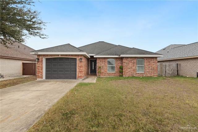 ranch-style home featuring a garage and a front lawn