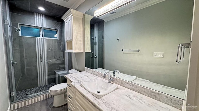 full bathroom with vanity, a shower stall, toilet, and crown molding