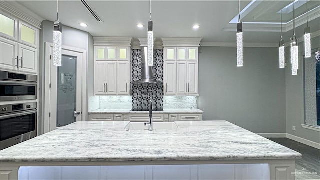 kitchen with stainless steel double oven, baseboards, white cabinets, ornamental molding, and tasteful backsplash