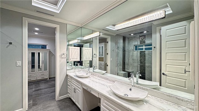 bathroom featuring a shower stall, crown molding, and a sink