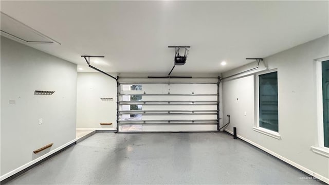 garage with baseboards and a garage door opener