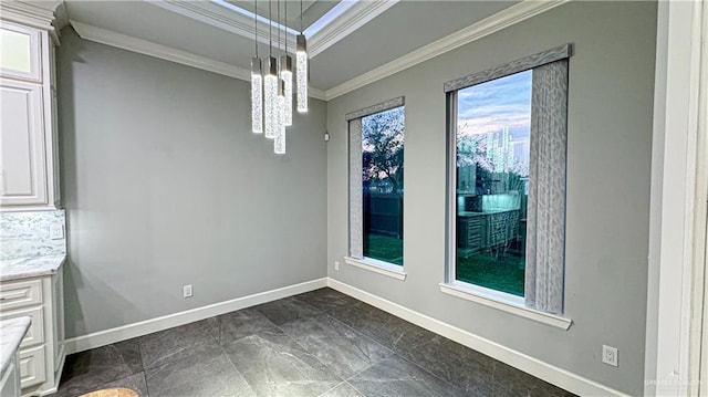 unfurnished dining area featuring baseboards and ornamental molding