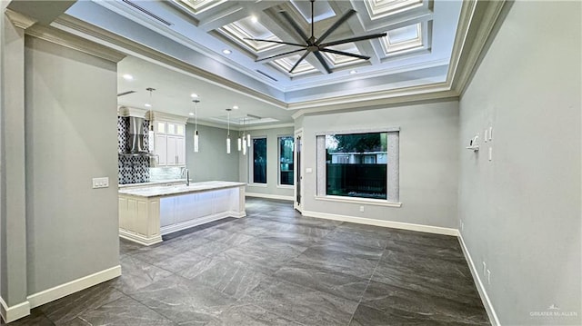 interior space featuring glass insert cabinets, coffered ceiling, crown molding, and baseboards