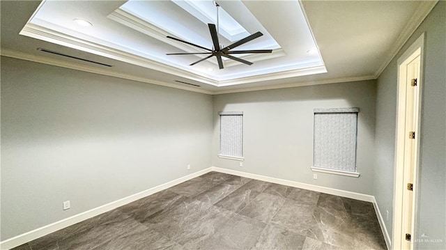 unfurnished room featuring a ceiling fan, baseboards, a tray ceiling, and crown molding