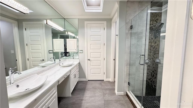 bathroom featuring double vanity, a stall shower, crown molding, and a sink