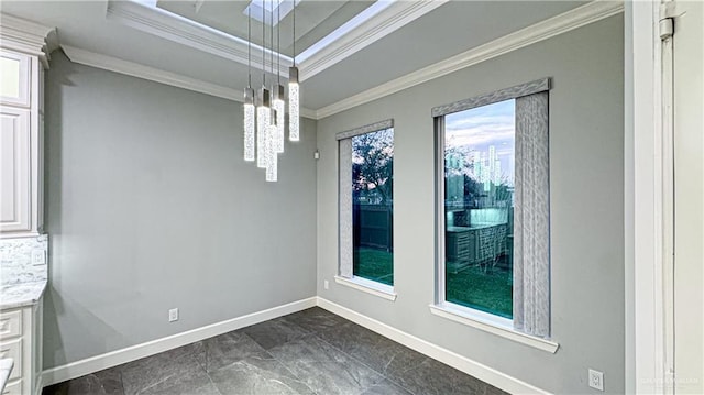 empty room featuring baseboards and crown molding