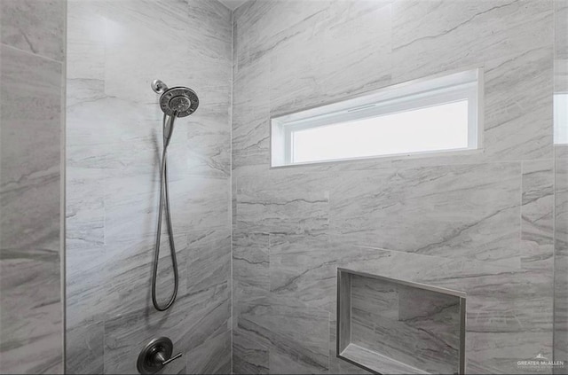 bathroom with a tile shower