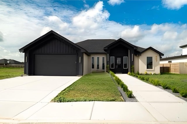 view of front of house featuring a front lawn and a garage