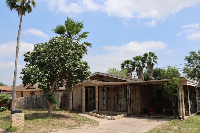 1100 Dormiendo St, Edinburg, TX 78539 - ranch-style house featuring fence, driveway, an attached carport, and brick siding