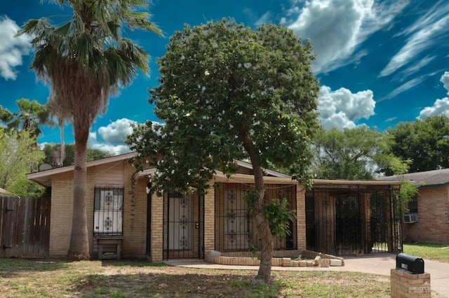 1100 Dormiendo St, Edinburg, TX 78539 - single story home featuring brick siding, fence, a gate, and cooling unit