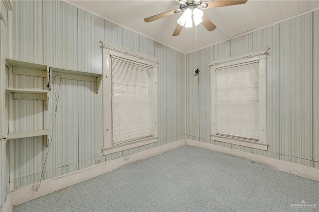 unfurnished room featuring ceiling fan and ornamental molding