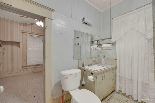 bathroom with toilet, crown molding, and vanity