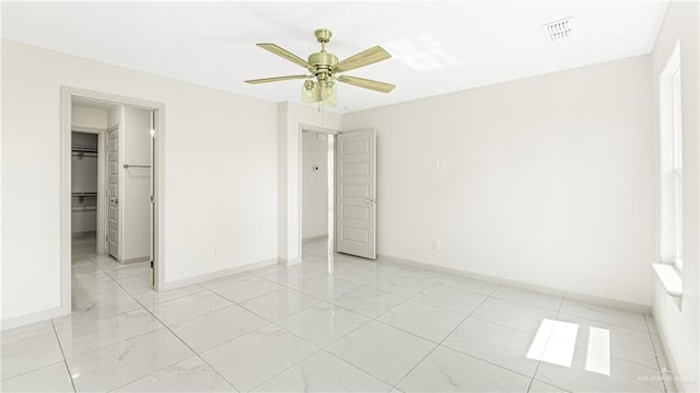 2201 Antelope Canyon St, Edinburg, TX 78541 - unfurnished bedroom featuring a walk in closet, a ceiling fan, and light marble finish flooring