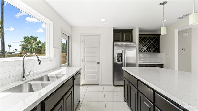 2201 Antelope Canyon St, Edinburg, TX 78541 - kitchen featuring stainless steel appliances, tasteful backsplash, decorative light fixtures, recessed lighting, and light stone counters