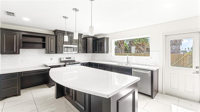 2201 Antelope Canyon St, Edinburg, TX 78541 - kitchen with appliances with stainless steel finishes, light marble finish floors, light countertops, open shelves, and tasteful backsplash