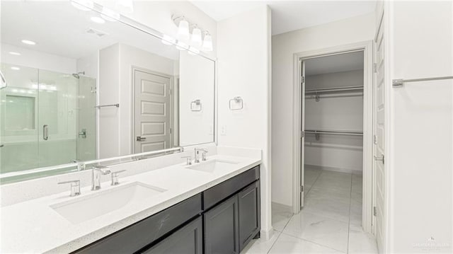 2201 Antelope Canyon St, Edinburg, TX 78541 - full bathroom with a shower stall, double vanity, a walk in closet, and marble finish flooring