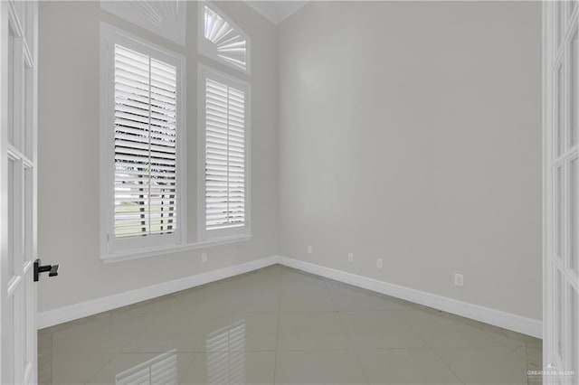 unfurnished room with light tile patterned flooring