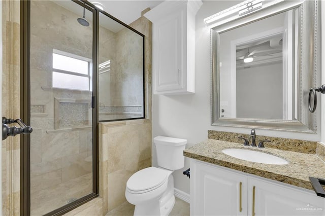 bathroom with ceiling fan, toilet, vanity, and walk in shower