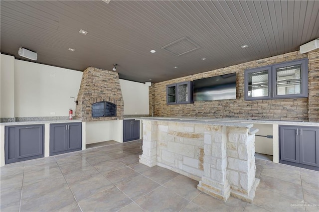 view of patio with a stone fireplace