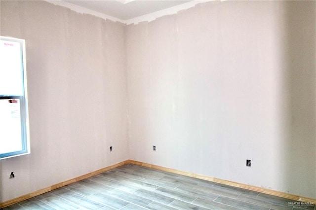 1334 S 9th St, Alamo, TX 78516 - spare room featuring wood finished floors and baseboards