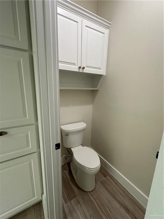 bathroom featuring hardwood / wood-style floors and toilet