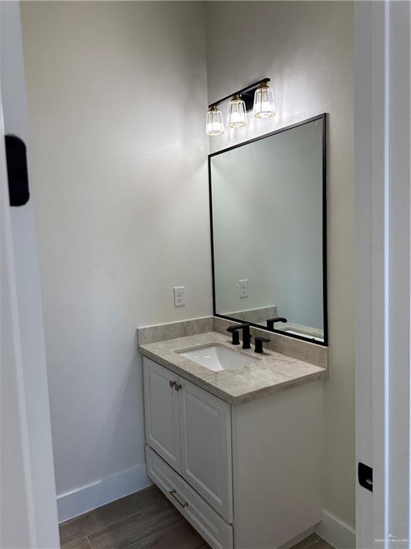 bathroom featuring vanity and wood-type flooring