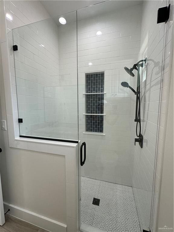 bathroom with a shower with shower door