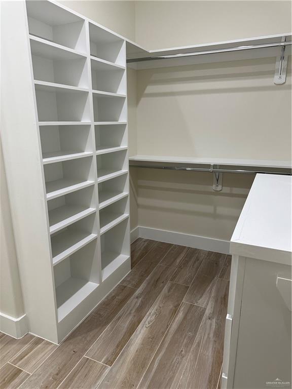 spacious closet featuring dark wood-type flooring