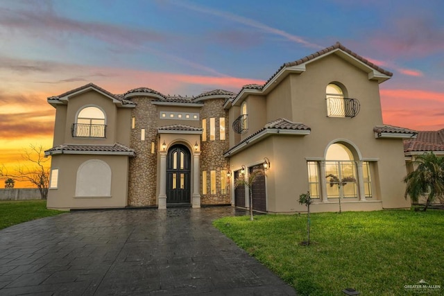 2806 S Woods Dr, Edinburg, TX 78542 - mediterranean / spanish home with stucco siding, french doors, a tiled roof, decorative driveway, and a front lawn