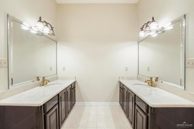 2806 S Woods Dr, Edinburg, TX 78542 - full bathroom featuring baseboards, a sink, and two vanities
