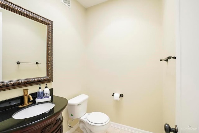 2806 S Woods Dr, Edinburg, TX 78542 - half bathroom featuring toilet, vanity, baseboards, and visible vents