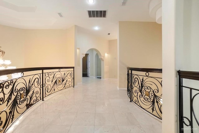 2806 S Woods Dr, Edinburg, TX 78542 - corridor featuring an inviting chandelier, marble finish floor, arched walkways, and visible vents