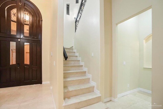 2806 S Woods Dr, Edinburg, TX 78542 - entryway with baseboards, stairway, and light tile patterned floors