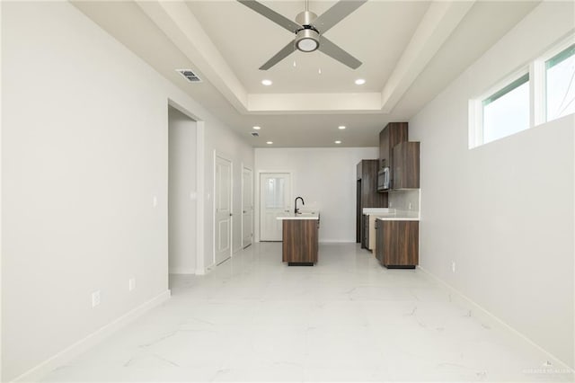 613 Cove Ln Unit 2, Weslaco, TX 78596 - unfurnished living room with light marble finish flooring, ceiling fan, recessed lighting, baseboards, and a sink