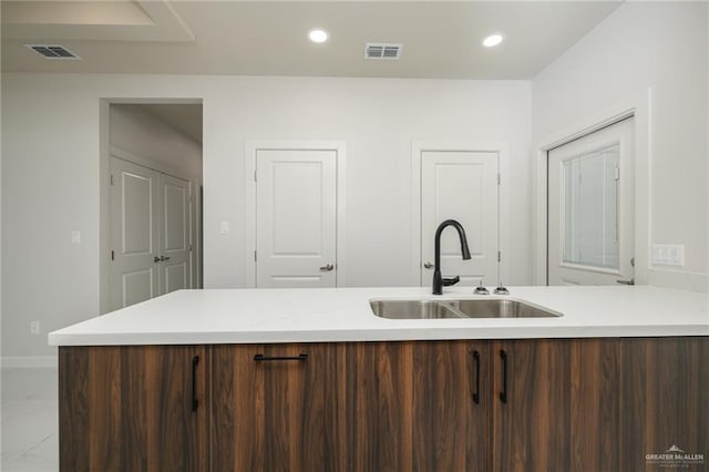 613 Cove Ln Unit 2, Weslaco, TX 78596 - kitchen featuring a sink, light countertops, recessed lighting, baseboards, and marble finish flooring