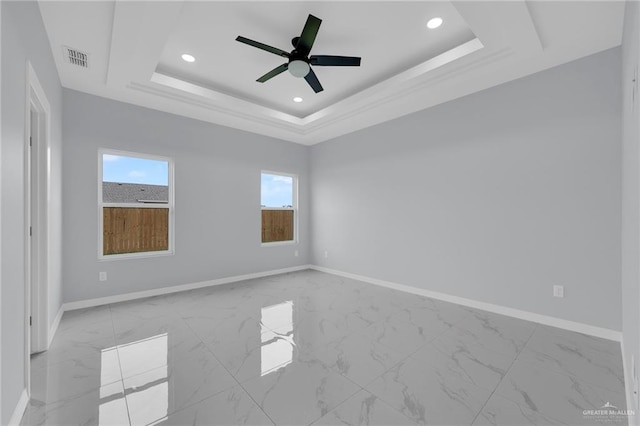 3107 S Auburndale Ave, Edinburg, TX 78542 - unfurnished room featuring healthy amount of natural light, marble look tile flooring, a raised ceiling, and recessed lighting