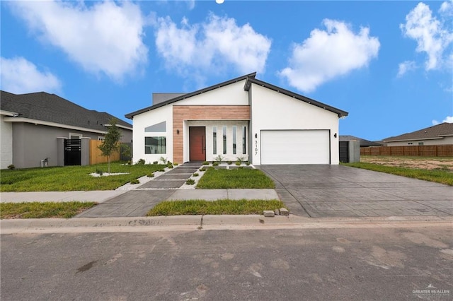 3107 S Auburndale Ave, Edinburg, TX 78542 - contemporary house featuring a garage, concrete driveway, and stucco siding